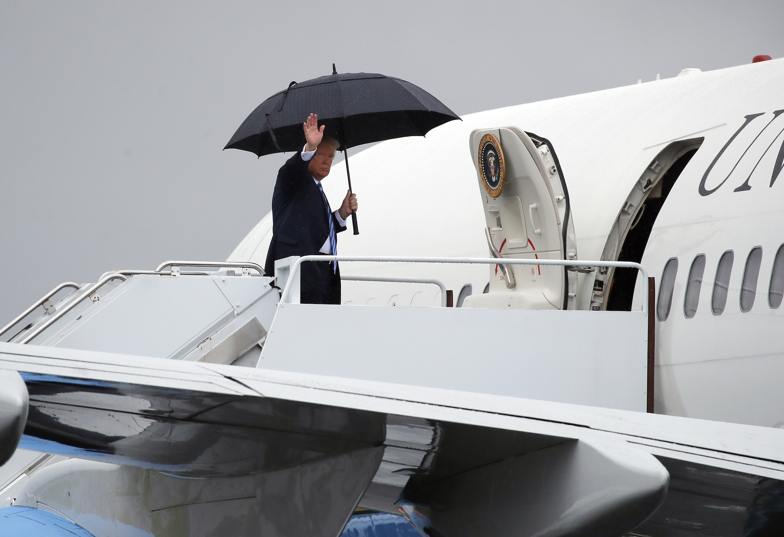 President Donald Trump waves as he boards a C-32 serving as Air Force One at Morristown Municipal Airport, in Morristown, N.J., on Aug., 13, 2018.
